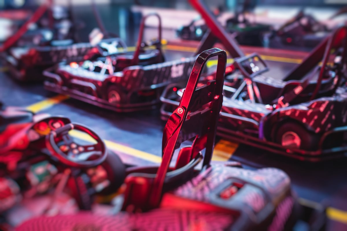 Wide view of the AFTERSHIFT indoor electric karting circuit under track lighting
